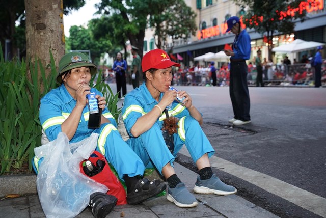 Ph&uacute;t nghỉ ngơi v&agrave; tiếp th&ecirc;m ch&uacute;t năng lượng bằng sữa tươi Vinamilk của c&aacute;c chị g&oacute;p phần quan trọng để đại lễ diễn ra với những tuyến đường sạch sẽ, ngăn nắp. (Ảnh: Vi Nam)