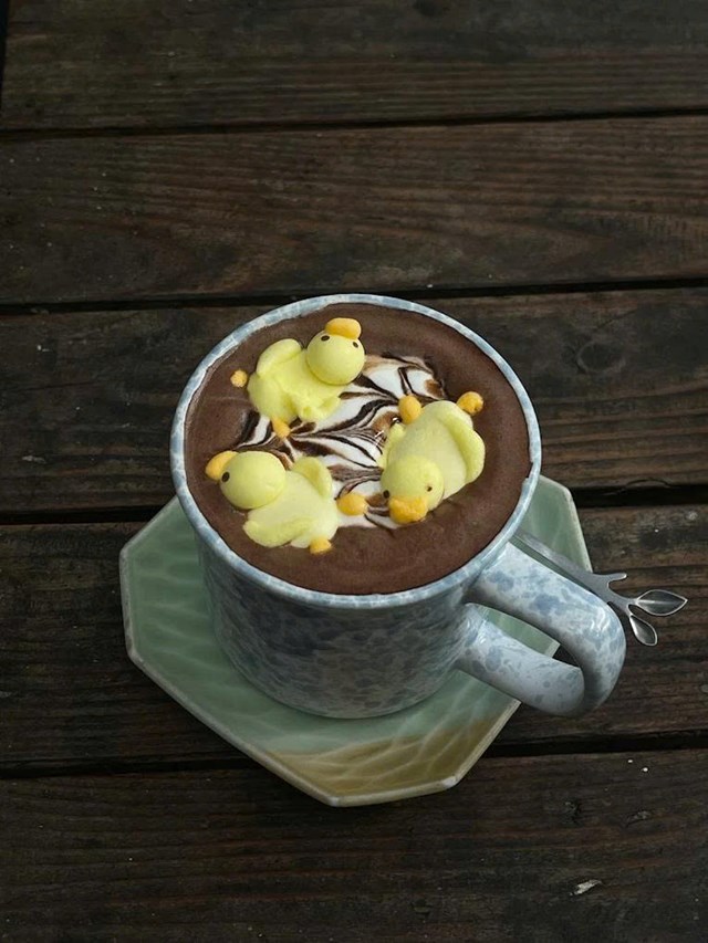 Qu&aacute;n Thi (phố Ho&agrave;ng Cầu) lại mang đến một n&eacute;t y&ecirc;n b&igrave;nh rất ri&ecirc;ng với kh&ocirc;ng gian tối giản, &aacute;nh đ&egrave;n ấm v&agrave; tiếng nhạc nhẹ nh&agrave;ng. M&ugrave;i cacao quyện c&ugrave;ng hơi sữa b&eacute;o ngậy len lỏi trong kh&ocirc;ng kh&iacute; khiến t&acirc;m hồn như được xoa dịu (Ảnh: Qu&aacute;n Thi)