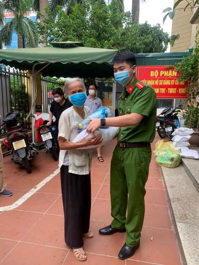 Lực lượng C&ocirc;ng an phường Dịch Vọng Hậu trao qu&agrave; v&agrave; những thực phẩm thiết yếu hỗ trợ b&agrave; con nh&acirc;n d&acirc;n c&oacute; ho&agrave;n cảnh kh&oacute; khăn, người lao động tự do, sinh vi&ecirc;n mắc kẹt tr&ecirc;n địa b&agrave;n phường - Ảnh: Sơn Thủy