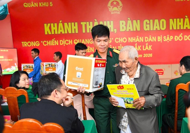 Niềm vui của người d&acirc;n khi nhận nh&agrave; mới c&ugrave;ng với c&aacute;c phần qu&agrave; do LLVT Qu&acirc;n khu 5 trao tặng - Ảnh: NNhật Anh