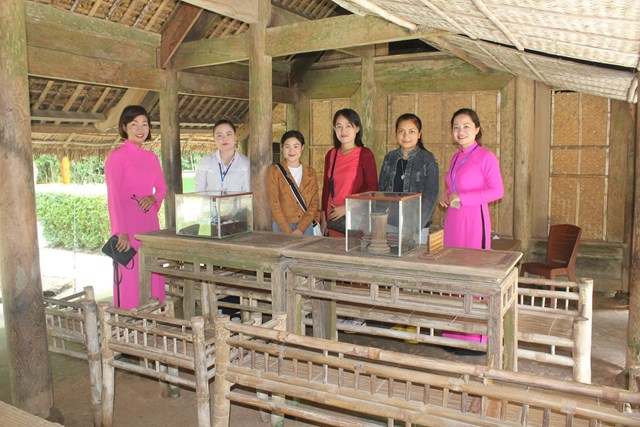 Tiến sĩ Sourin (&aacute;o đ&oacute;, giữa) v&agrave; c&aacute;c sinh vi&ecirc;n L&agrave;o thăm qu&ecirc; B&aacute;c, chụp ảnh lưu niệm với hướng dẫn vi&ecirc;n Khu di t&iacute;ch (ảnh Quốc Kh&aacute;nh)