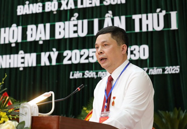 Đồng ch&iacute; Nguyễn Thanh B&igrave;nh, Ph&oacute; B&iacute; thư Thường trực Đảng ủy x&atilde; tr&igrave;nh b&agrave;y t&oacute;m tắt B&aacute;o c&aacute;o ch&iacute;nh trị tr&igrave;nh Đại hội.